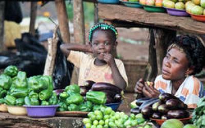 A mother and child sell vegetables at a roadside stand in Kampala, Uganda. © 2011 Rachel Steckelberg, Courtesy of Photoshare